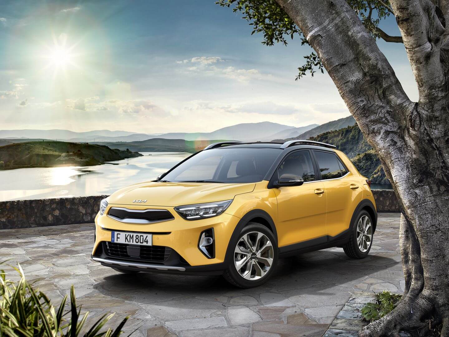 SUV Kia Stonic amarelo ao lado de um rio